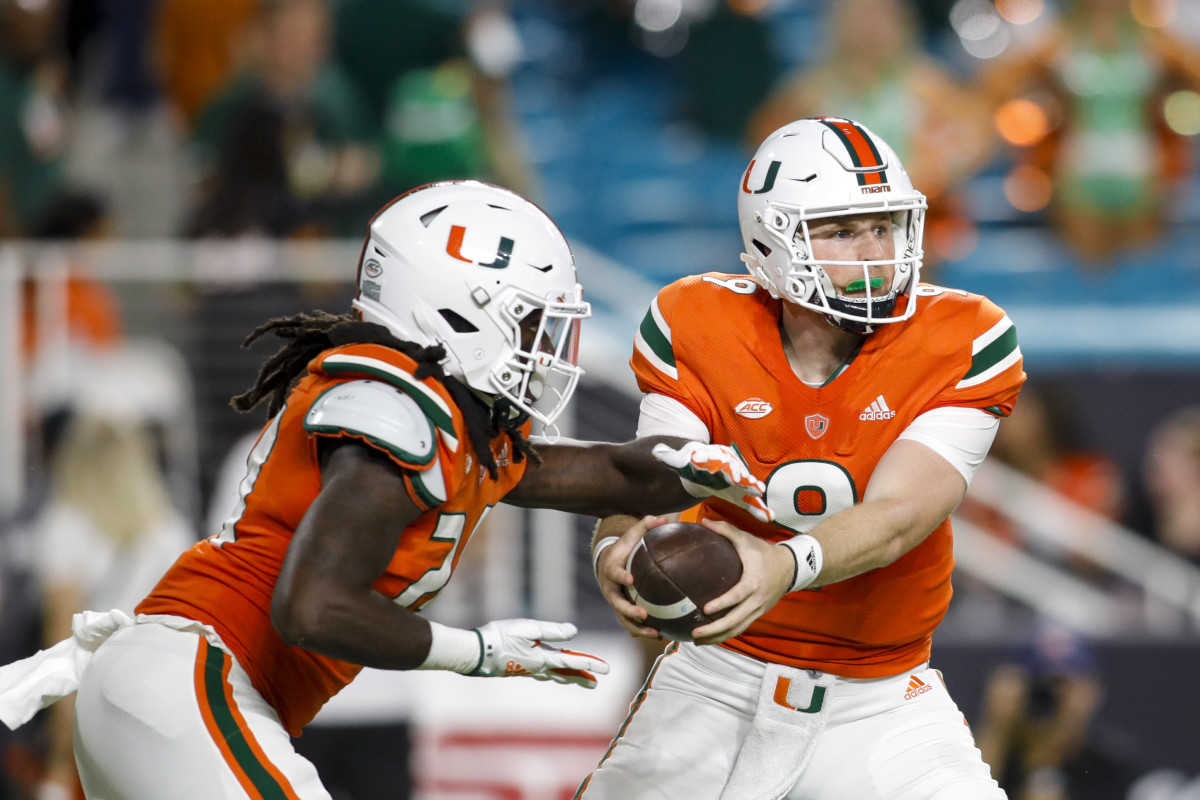 Miami’s Tyler Van Dyke hands the ball off.